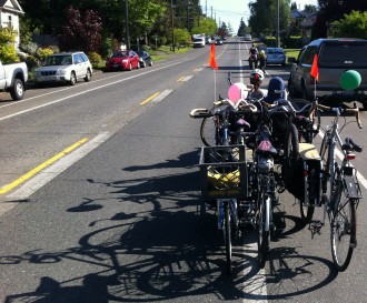 Morgan hauls herself, six bikes and a passenger on her electric-assisted trike.