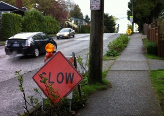 Community-installed signs requesting drivers to slow down and watch for pedestrians