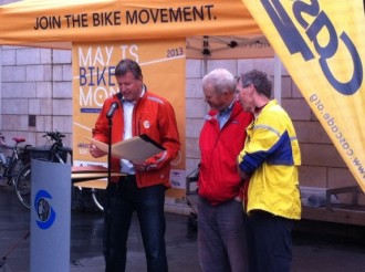 At Bike to Work Day rally, Mike O'Brien reads Council document praising the work of Cascade's Chuck Ayers