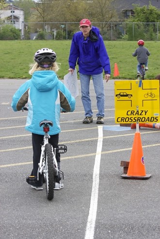 Teaching biking skills at a West Woodland Elementary bike rodeo (photo courtesy Polly Freeman)