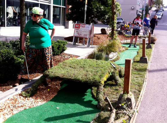 Cathy Tuttle of Seattle Neighborhood Greenways plays putt-putt golf in South Lake Union. PARK(ing) Day 2013