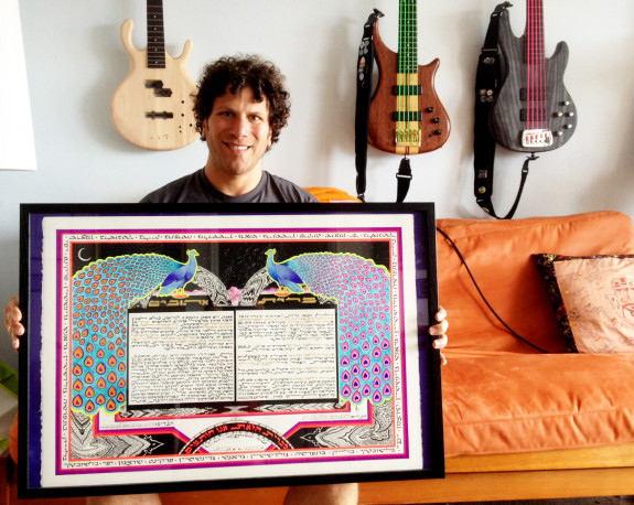 Brandon Blake holds the ketubah he made joining him with his wife Sabrina. Blake's brain injury has not stopped him from continuing his art.
