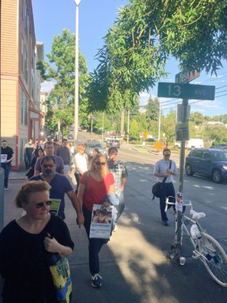 Friends, family and community members walk in honor of McCloud. Her ghost bike sits at 13th and Yesler.