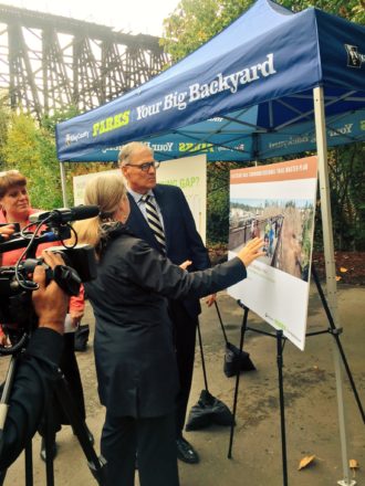 Governor Inslee checks out a concept for a completed trail on the trestle.