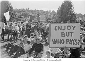 Photo from MOHAI: Rally Against the Burke Gilman Trail, Seattle, 1971 Signs in image: Do the Hungry and Needy Really Want [...] Million Trail. [...] Woods [...] in My Yard. Not More Taxes. Who's Paying for This $10 Million Dream? We Don't Want It. Burke Gilman Trail. Enjoy But Who Pays? Who Pays for Upkeep. Photographer: Tom Barlet Image Date: 1971 Image Number:1986.5.55062.1 - See more at: http://www.mohai.org/explore/blog/item/2067-rally-against-the-burke-gilman-trail-seattle-1971#sthash.3mRtlXsn.dpuf