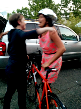 Alex Cruse (left) and Zanna Furness mark the bike reunion with a hug. Image from Nicole Southwell.