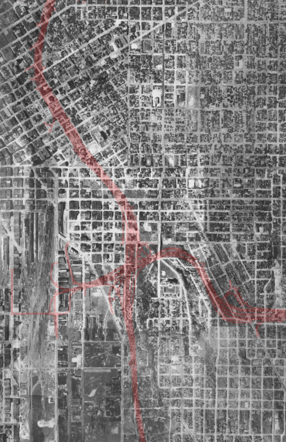 I-5 and I-90 in red imposed on top of an aerial photo of Seattle from 1936.