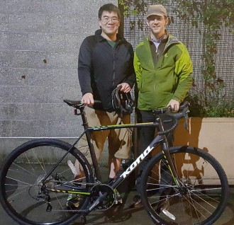 Howell (right) delivering a crowdfunded Kona to Fan, who returned Howell's stolen bike after unknowingly buying it through Offerup.