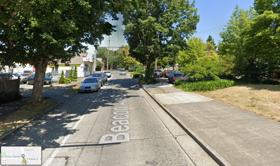 Photo of a street. The sidewalk in the median turns into a parking lot.