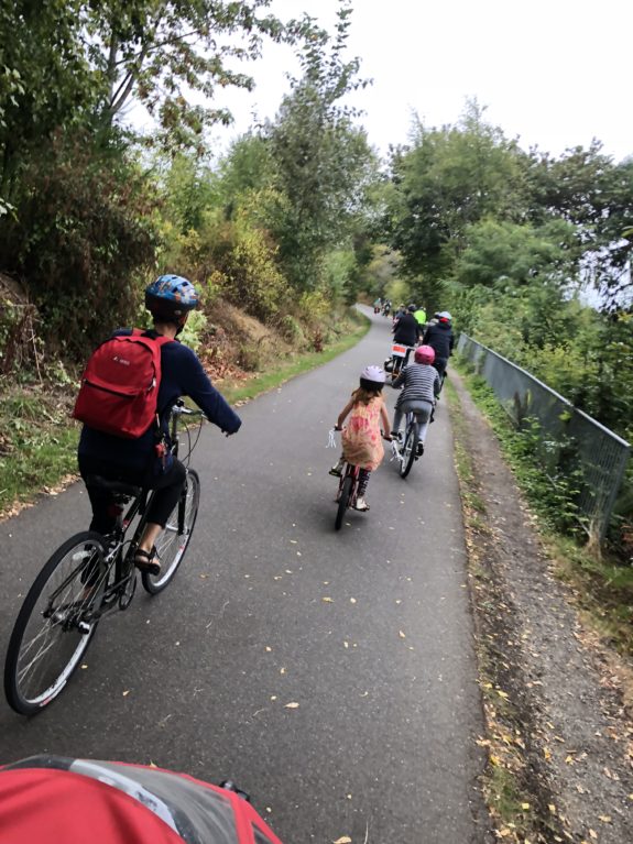Photo of parents and kids biking on a trail together.