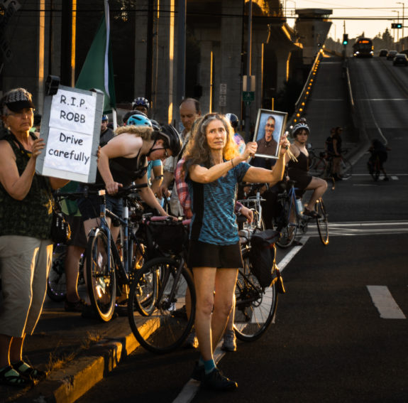 Claudia Mason holds a photo of Robb during a Critical Mass memorial.