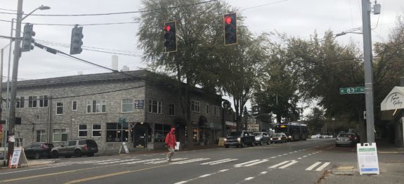 Photo of someone crossing the new crosswalk with a traffic signal.