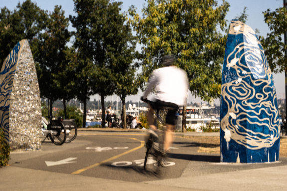 Photo of a person biking between the sculptures.