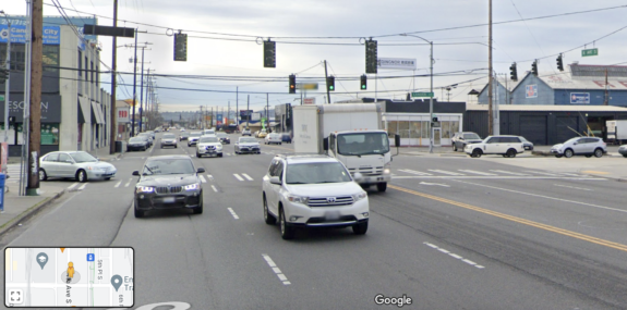 Photo of a six-lane road intersecting a five-lane road in an industrial area.