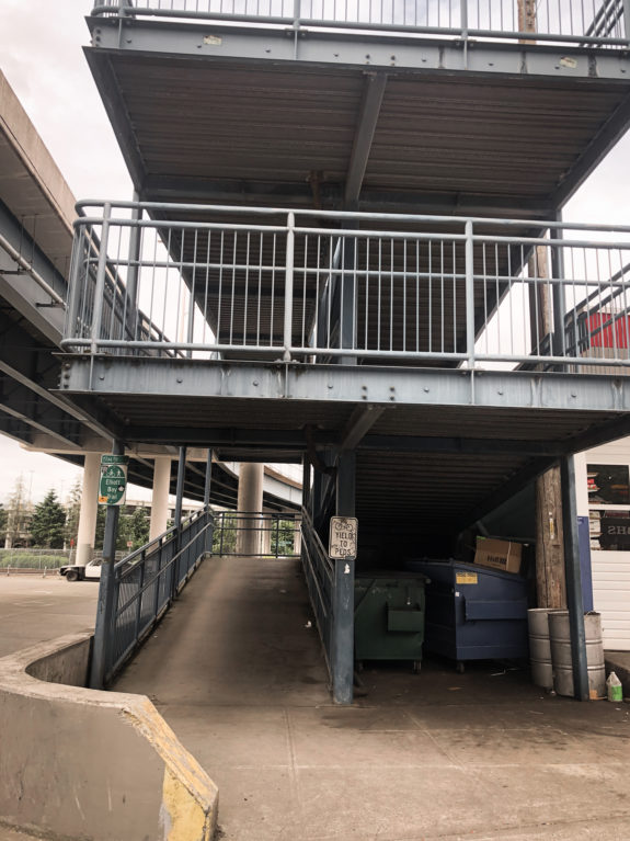 A multi-storey ramp lowers the path from the flyover bridge to street level
