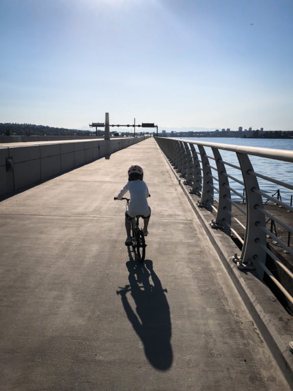 A child biking in the 520 Bridge Trail.