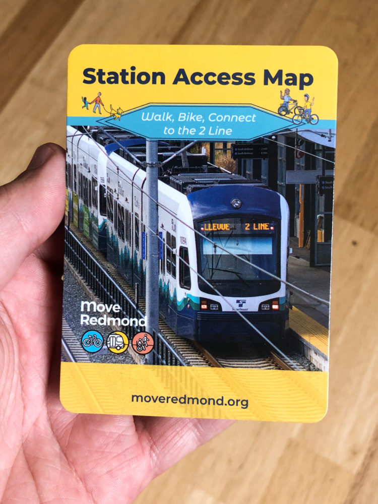 A hand holding a pocket-sized copy of the Station Access Map.